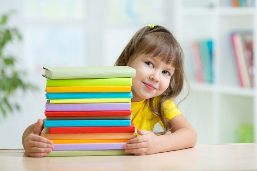 Smart kid girl preschooler with books