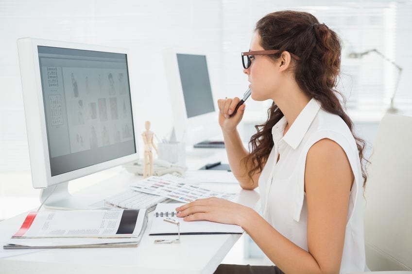 Concentrated businesswoman using computer monitor in the office